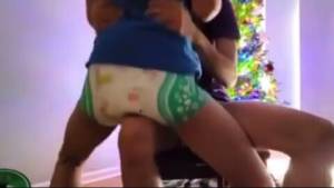 Click to play video Forced to bounce messy diaper on knee