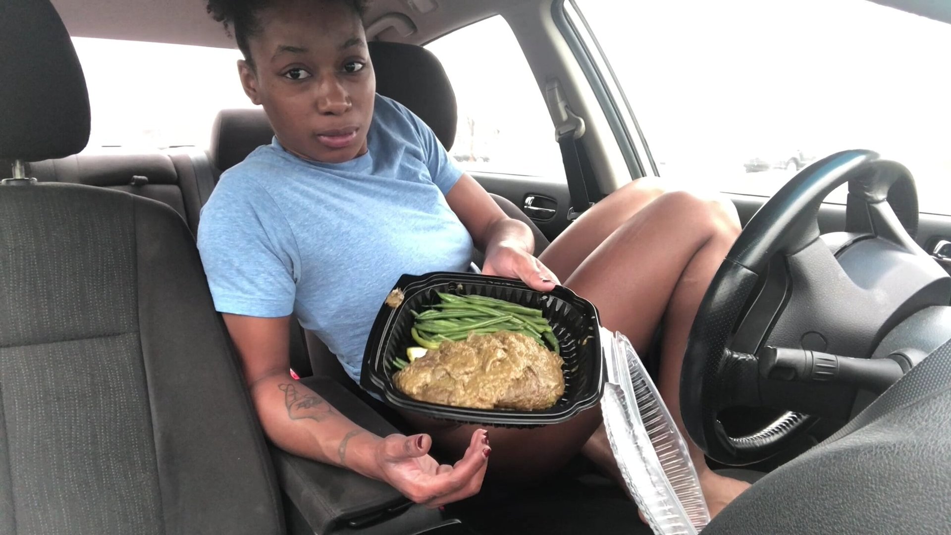 Click to play video A black chick pooping in her car. 